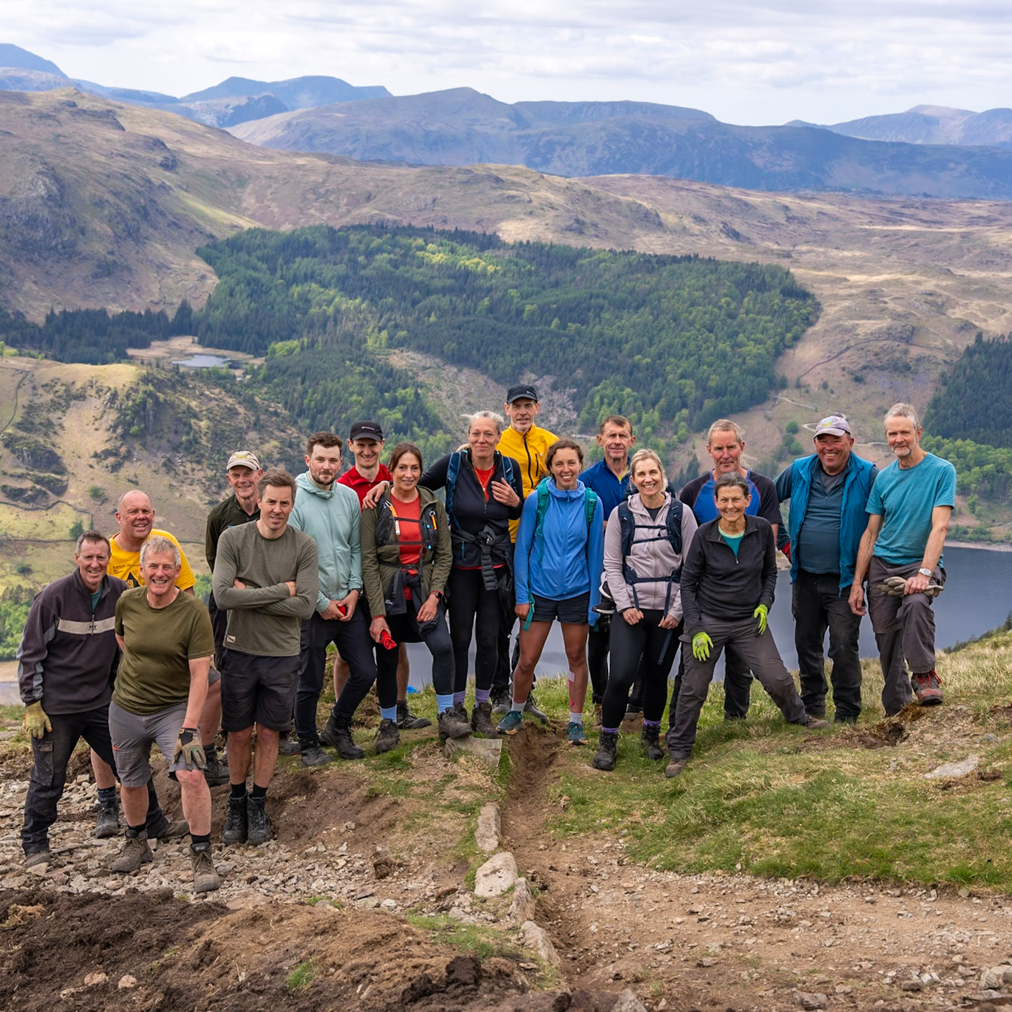 Group of Montane staff posing for a photo in a mountainous landscape.