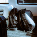 Two Montane bags on a vehicle seat with a window in the background