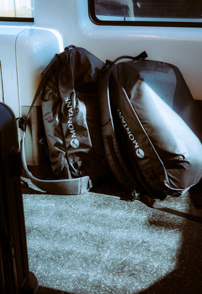 Two backpacks with 'Montane' branding on a vehicle floor.